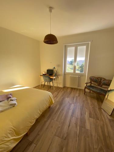 a bedroom with a bed and a desk and a window at Casa Vacanze Nene in Minturno
