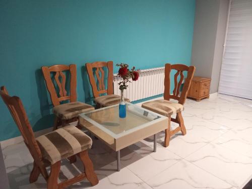a dining room with a table and four chairs at Willa Mateusza in Sandomierz