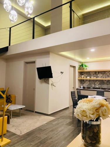 a loft apartment with a staircase and a living room at Loft Platino in Pachuca de Soto