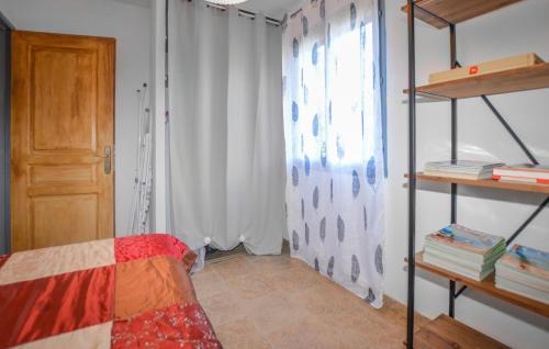 a bedroom with a bed and a window and shelves at Lovely Apartment In Sarrola Carcopino in Sarrola-Carcopino