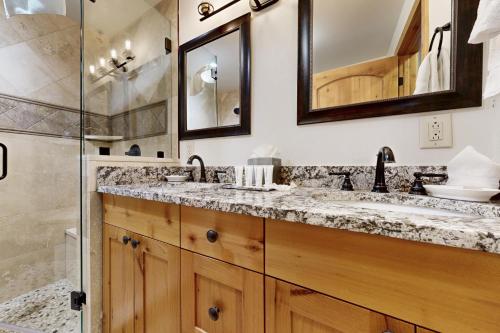 a bathroom with two sinks and a shower at Lion Square Lodge East 310A in Vail