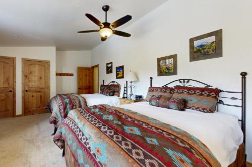 a bedroom with two beds and a ceiling fan at Lion Square Lodge East 310A in Vail