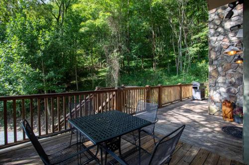 a patio with a table and chairs on a deck at Moose Preserve in Sugar Grove