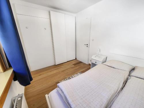 a small bedroom with a bed and a window at Ferienwohnung Parsenn Peaks Panorama in Davos