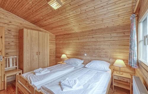 a bedroom with a bed in a wooden room at Amazing Home In Masserberg With Wifi in Fehrenbach