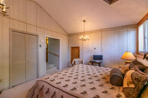 a bedroom with a large bed and a bathroom at Endless Vistas in Seven Devils