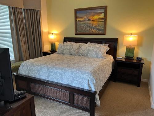 a bedroom with a bed and two night stands with lamps at GreenLinks Luxury Villa at Lely Resort Golf - 3 Bedrooms in Naples
