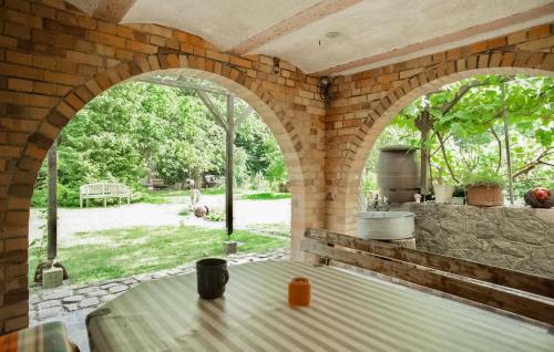 an outdoor kitchen with an archway and a table at Ferienwohnung Klink in Klink