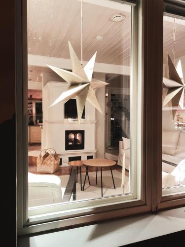 a room with a window with a table and stars at Winter Wonderland Home in Rovaniemi