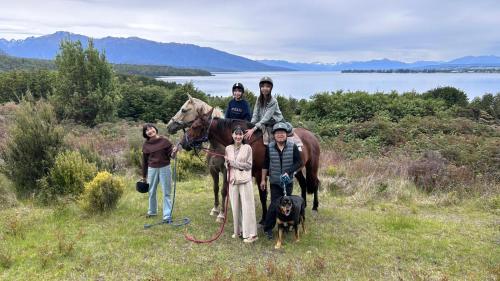 a group of people posing for a picture with a horse at Kepler Oaks Chalet in Te Anau