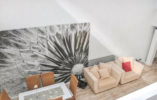 a living room with a couch and a flower mural at Ferienhaus Neubrandenburg in Neubrandenburg