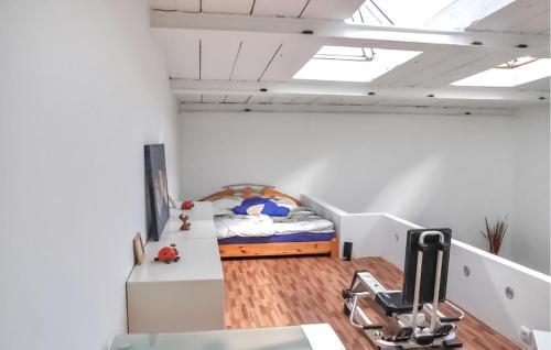 a small bedroom with a bed and a desk at Ferienhaus Neubrandenburg in Neubrandenburg