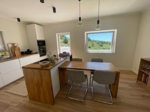 a kitchen with a wooden table and chairs at Villa Mave - Cascais in Estoril