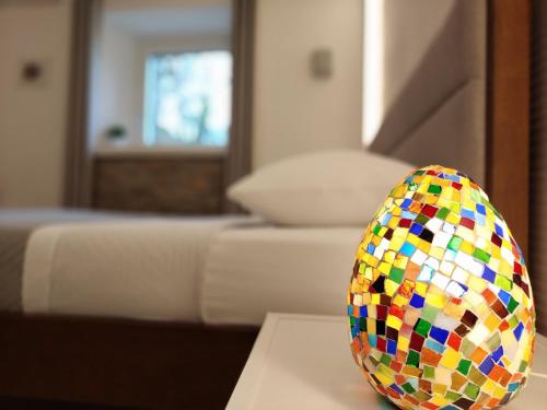 a colorful egg sitting on a table in a living room at Panorama Suite in Piazza Armerina