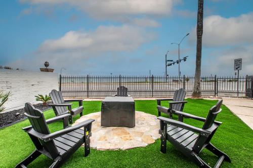 three chairs and a monument in the middle of a lawn at Luxury on Ocean Drive - Sleeps 28 in Corpus Christi