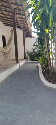 a patio with a hammock in a building at Casa Recanto in Trancoso