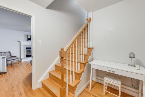 a staircase in a home with white walls and wooden floors at Group Getaway about 15 Mi to Charlottesville! in Zion Crossroads