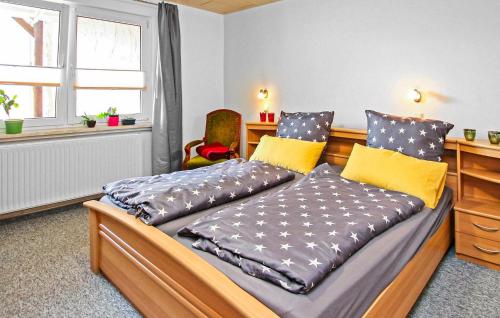 a bedroom with two beds and a desk and a window at Ferienwohnung Röbelmüritz in Röbel
