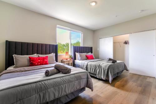 a bedroom with two beds and a window at Spacious 3BR Townhouse with Free Parking Included! in Miami
