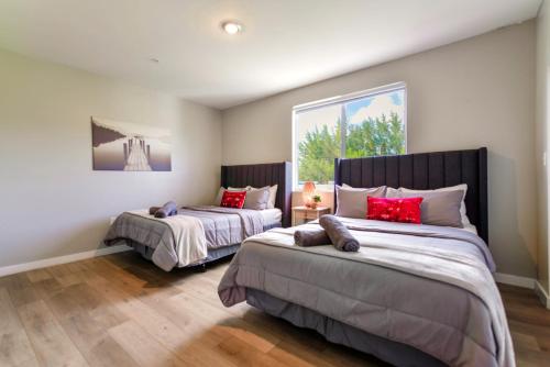 a bedroom with two beds with red pillows at Spacious 3BR Townhouse with Free Parking Included! in Miami
