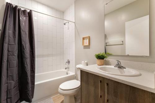 a bathroom with a sink and a toilet and a tub at Spacious 3BR Townhouse with Free Parking Included! in Miami