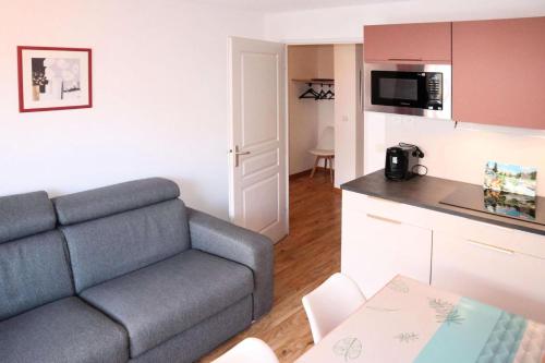 un salon avec un canapé et une cuisine dans l'établissement Les Chalets De Bois Mean - Résidence le Bois Méan 2 pièces pour 6 personnes MAE-6814, aux Orres