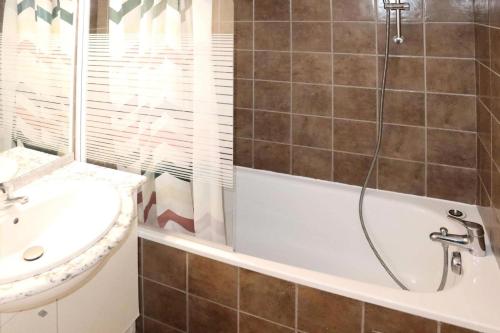 une salle de bain avec une baignoire et un lavabo dans l'établissement Les Chalets De Bois Mean - Résidence le Bois Méan 2 pièces pour 6 personnes MAE-6814, aux Orres