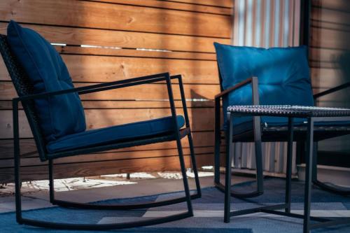 two blue chairs sitting next to each other at Rustic Meets Modern 2BR 2BA in Greenville