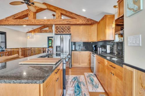 a large kitchen with wooden cabinets and a ceiling at Downs By The River 2 Bedrooms 1 Bathroom in Prince Frederick