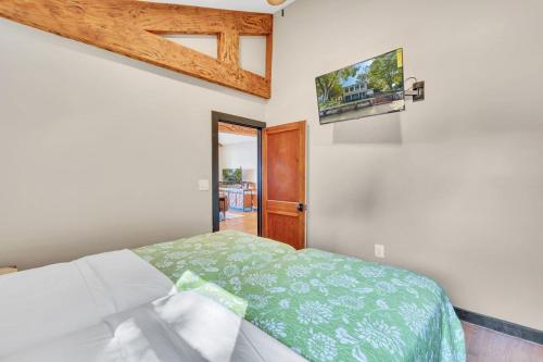 a bedroom with a bed and a tv on the wall at Downs By The River 2 Bedrooms 1 Bathroom in Prince Frederick