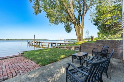 a couple of benches sitting next to a body of water at Downs By The River 2 Bedrooms 1 Bathroom in Prince Frederick