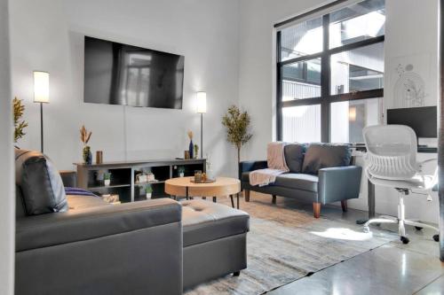 a living room with a couch and a chair at Luxurious 2 Bedroom 2 Bathroom in Greenville