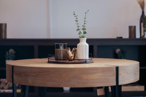 a wooden table with a vase on top of it at Luxurious 2 Bedroom 2 Bathroom in Greenville