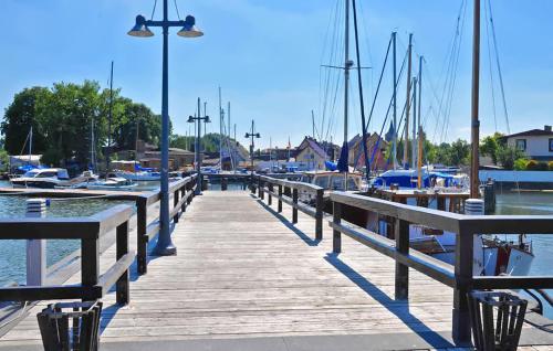 a wooden dock with boats in a marina at Ferienhaus Lassan Bei Wolgast in Lassan