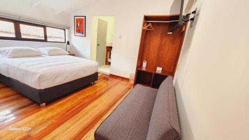 a bedroom with a bed and a couch in it at Solara Art Hotel by Amak in Cusco