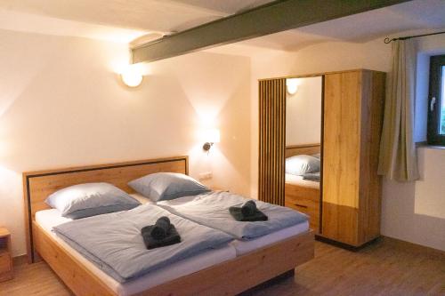 a bedroom with a bed with two shoes on it at Ferienwohnung "Wasser" mit Sauna im Ferienhaus am Waldbach in Kirchzell