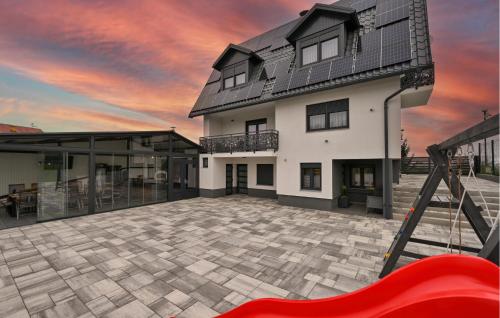 a house with a large patio with a red slide at Stunning Home In Vinogradi Ludbreski in Vinogradi Ludbreški