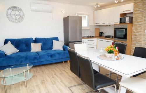a living room with a blue couch and a table at 3 Bedroom Amazing Home In Vinovac in Kruševo