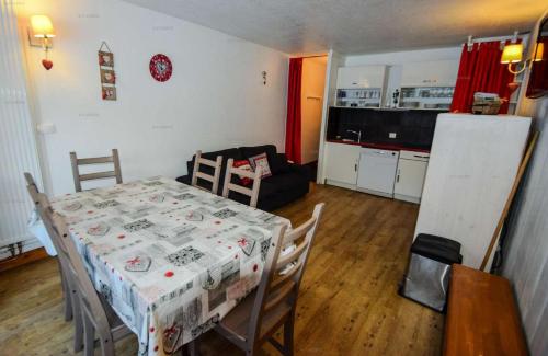 une cuisine et une salle à manger avec une table et des chaises dans l'établissement Résidence Le Serro Torre - 3 Pièces 6 pers - LE CERRO TORRE - PLAGNE CENTRE MAE-1111, à La Plagne Tarentaise