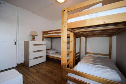 une chambre avec deux lits superposés et un bureau dans l'établissement Résidence Le Serro Torre - 3 Pièces 6 pers - LE CERRO TORRE - PLAGNE CENTRE MAE-1111, à La Plagne Tarentaise