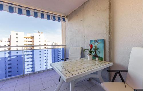 a room with a table and chairs on a balcony at Cozy Apartment In Villajoyosa With Wifi in Villajoyosa