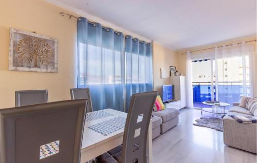 a living room with a dining room table with a laptop at Cozy Apartment In Villajoyosa With Wifi in Villajoyosa