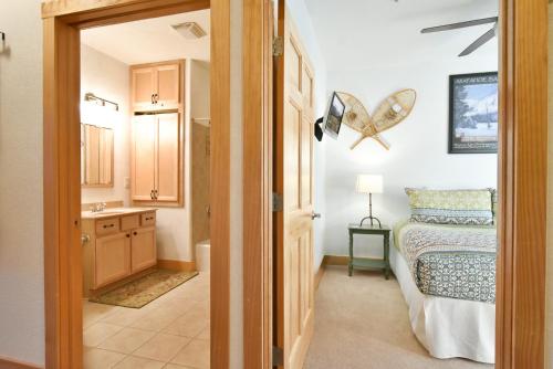 a bathroom with a bed and a sink in a room at La Riva Del Lago Condo: Downtown, Close to Everything! in Dillon
