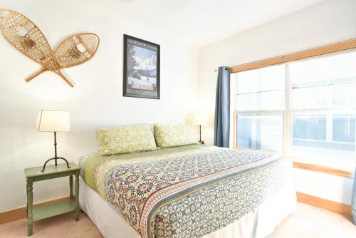 a bedroom with a bed and a window at La Riva Del Lago Condo: Downtown, Close to Everything! in Dillon