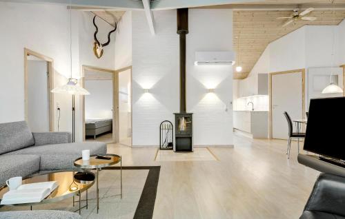 a living room with a couch and a fireplace at 4 Bedroom Stunning Home In Hadsund in Hadsund