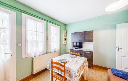 - une cuisine avec des murs verts et une table avec des chaises dans l'établissement 1 Bedroom Beautiful Home In Royan, à Royan