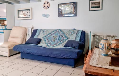 - un canapé bleu et une chaise dans le salon dans l'établissement Beautiful Home In La Teste-De-Buch, à La Teste-de-Buch
