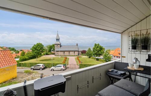 a balcony with a view of a church at Amazing Apartment In Gudhjem in Gudhjem