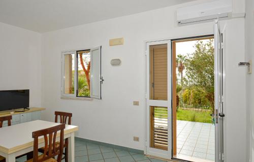 a room with a dining table and a sliding glass door at Nice Home In Ragusa With Wifi in Ragusa