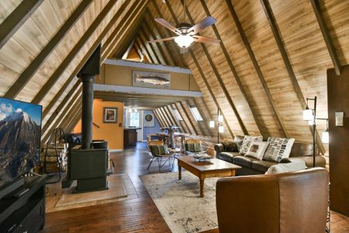 a living room with a ceiling fan and a couch at Spruce Creek Lodge: Classic A-Frame Mountain Retreat in Blue River